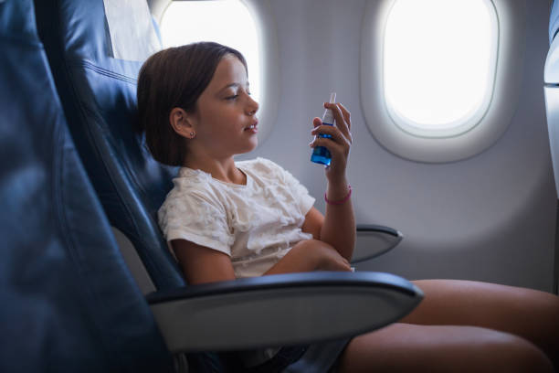 istock Child using nasal spray at airplane 1447987472