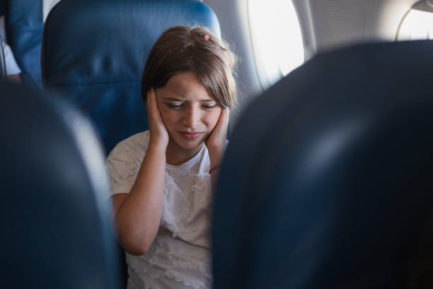 Child crying due to earache during a plane flight stock photo