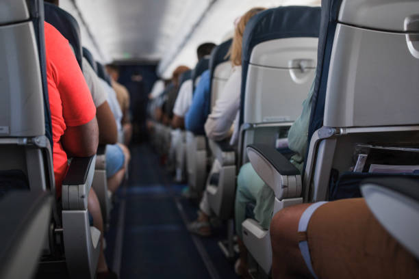 istock People sitting at an airplane 1447987713