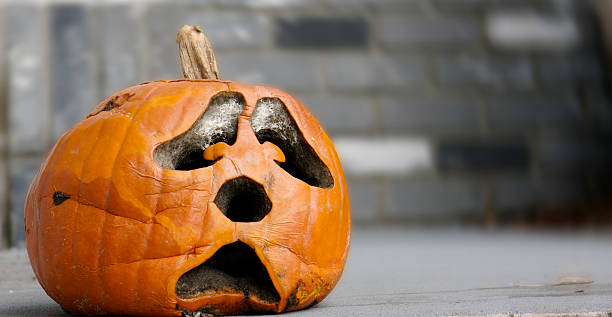 Decaying Pumpkin A sad decaying pumpkin waitng for the end of Halloween. decay stock pictures, royalty-free photos & images