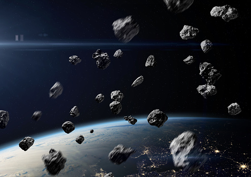 Asteroids near Earth. Meteorites orbiting planet. Science fiction art. Elements of this image furnished by NASA. ______ Url(s): https://images.nasa.gov/details-iss040e074978.html  https://photojournal.jpl.nasa.gov/catalog/PIA17257  https://svs.gsfc.nasa.gov/30028