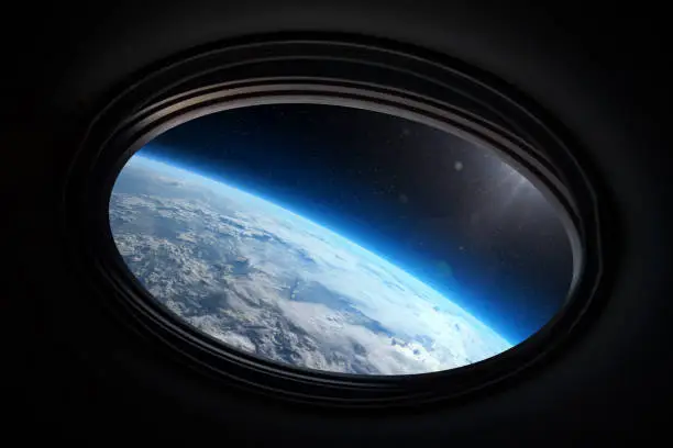 Photo of View from porthole of a spaceship to Earth planet