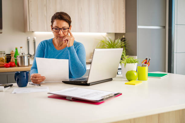 istock Serious woman working at home 1447991683