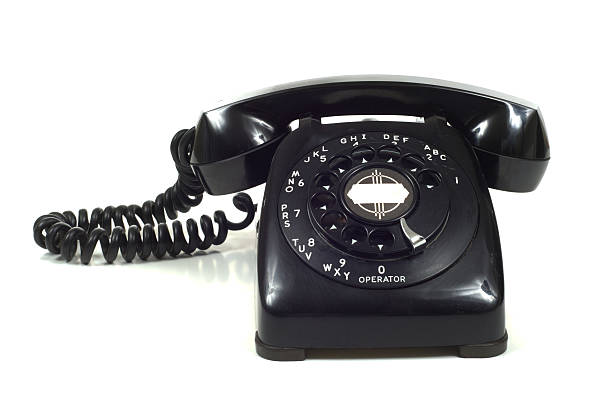 Vintage Telephone A black vintage, 1950's telephone on white background alexander graham bell stock pictures, royalty-free photos & images