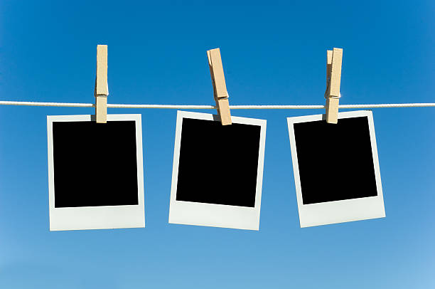 istock Three blank photographs hanging on a clothesline 144799417