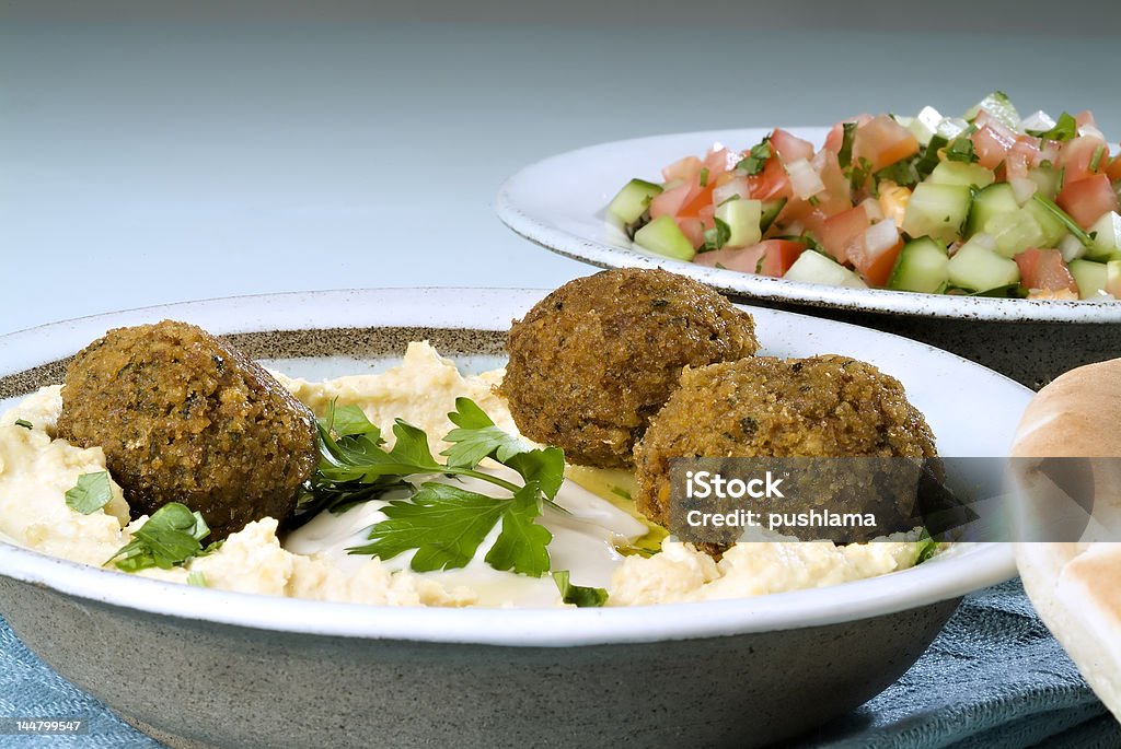 hummus falafel and arabic salad Falafel balls with hummus, arabic salad, pita and a tahini sauce. Appetizer Stock Photo