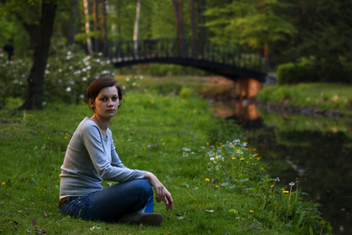 girl sitting near the river