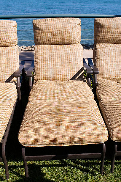 Lawn chairs by the water stock photo