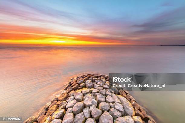 Breakwater Ijsselmeer At Sunset Stock Photo - Download Image Now - Groyne, Jetty, Backgrounds