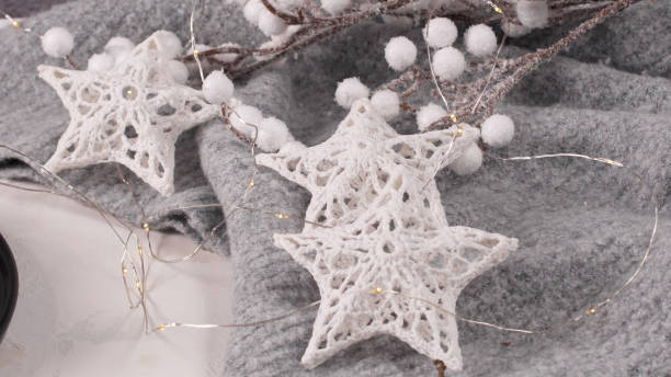 istock Stars with lights on gray woolen background 1448000527