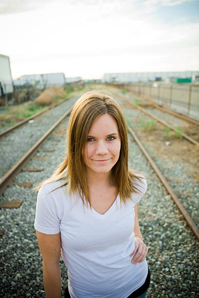 indie girl on train tracks stock photo