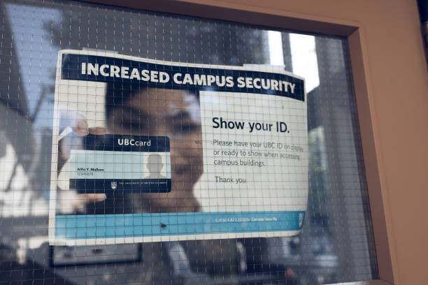 View of sign Increased Campus Security at one of the building at University of British Columbia stock photo