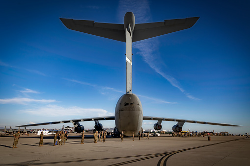 San Diego, California, USA - September 23, 2022: US Marines conduct a FOD Walkdown (Foreign Object Debris) near a C5 Galaxy at the end of the day during the 2022 Miramar Airshow.