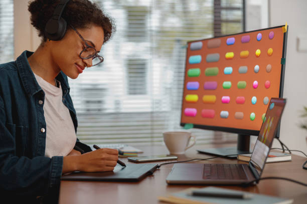 istock Woman designer works in home office drawing on graphic tablet. Freelancer working on project 1448003596
