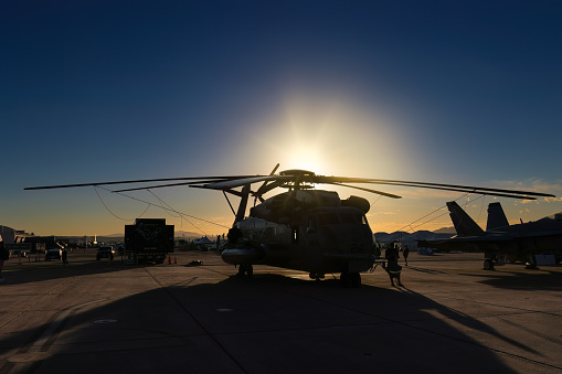 San Diego, California, USA - September 23, 2022: The silhouette of a CH-53 Sea Stallion helicopter as the sun rises at the 2022 Miramar Airshow.