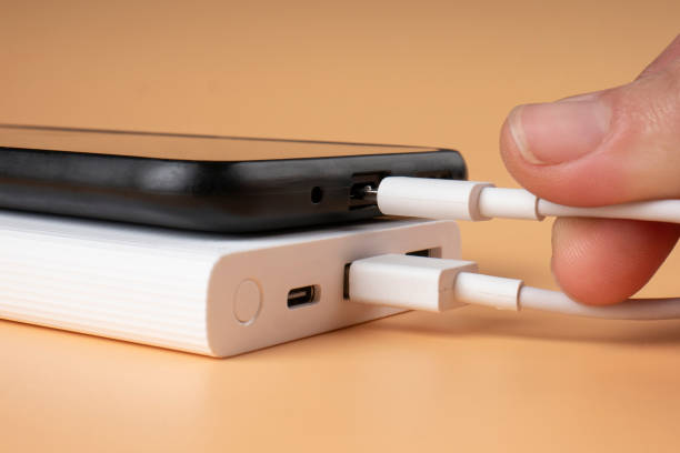 istock charging smartphone from power bank, extra battery for phone 1448004948