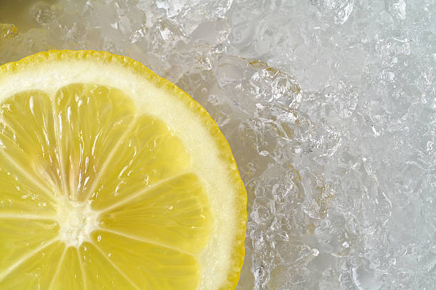 Lemon slice on crushed ice stock photo