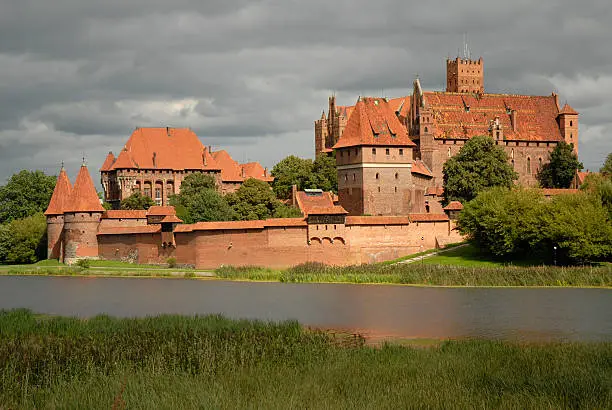 Malbork castle from opposite river bank eventually highlighted with the sun