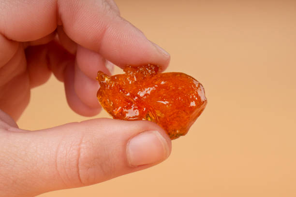 istock orange rosin hash cannabis extract with high thc in hand 1448007181