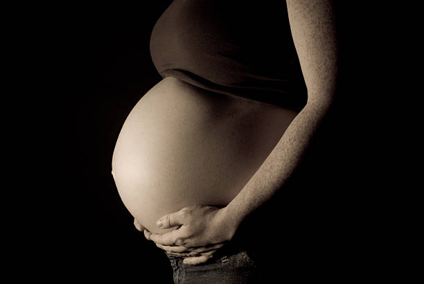 istock Anonymous Pregnant Women Holding Belly 144800784