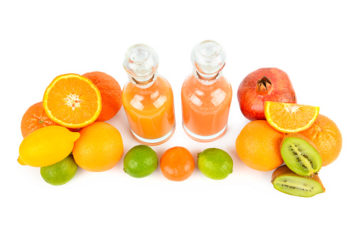 Set of citrus fruits and fruit juice bottles isolated on white background.