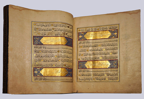 Toronto, Canada - December 2 2022:  Ancient illuminated manuscript of the Koran, the holy book of Islam, from Persia in the 1500s, in the collection of the Aga Khan Museum.  Photography is permitted:  https://agakhanmuseum.org/visit/photography.html