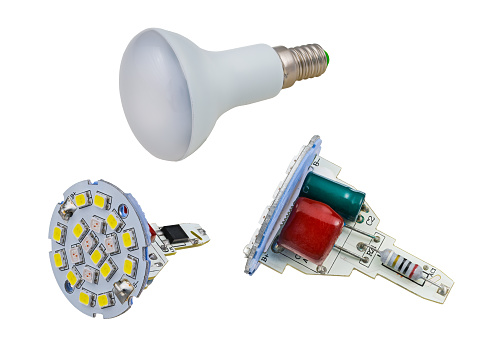 Household lamp with screw socket, capacitor or color coded resistor and yellow diodes on cooling aluminum PCB