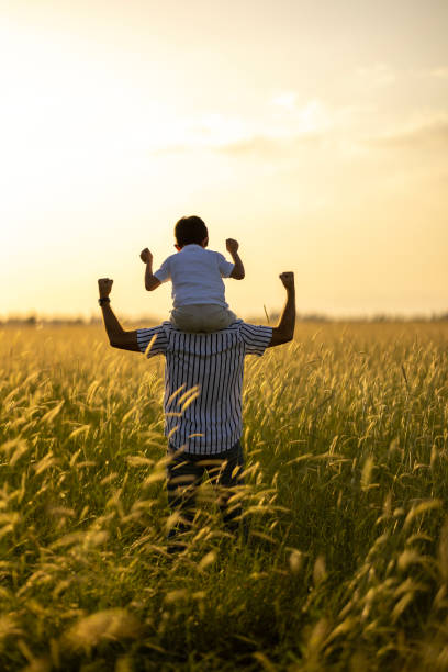 istock Dad holding his son on shoulders. 1448013456