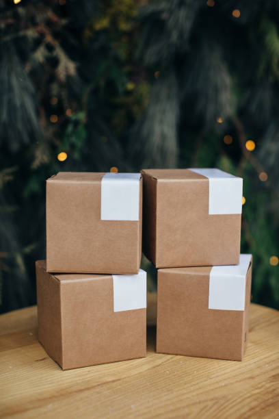 istock Mockup. Kraft paper boxes with white stickers on Christmas background. 1448015037