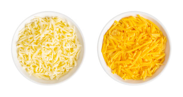 Shredded mozzarella and cheddar cheese for pizza and pasta, in white bowls