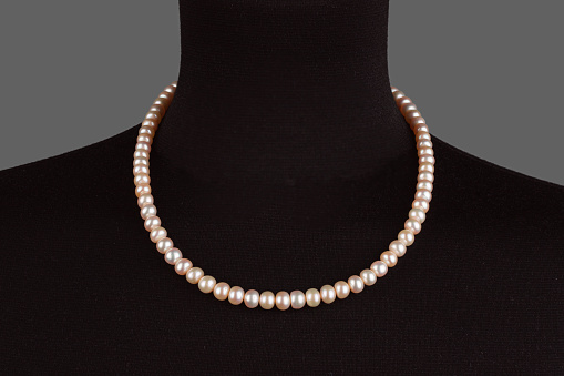 two strings of natural pink pearls, beads, isolate on a black background