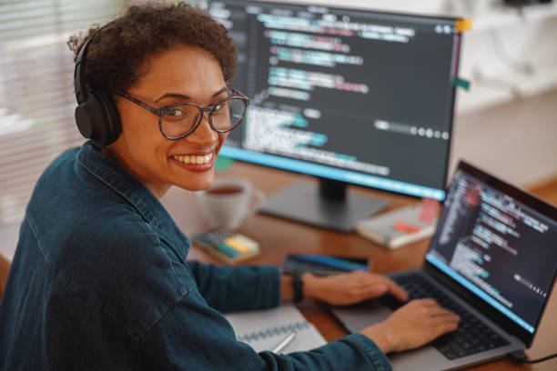Female freelancer making new project as web designer and programmer on her computer at home office stock photo