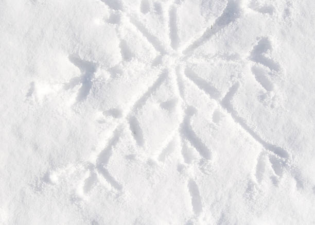 finger drawn snowflake in the sparking snow