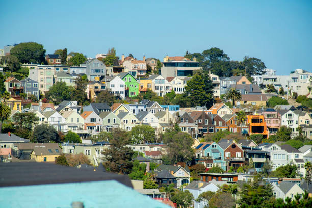 istock A great many houses on ridge with homes on crest and visible trees in back and front yard and blue and white gradient sky in sun 1448021112