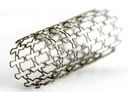 This is a stent, on white background. A stent is a small mesh tube that’s used to treat narrowed or weakened arteries in the body.