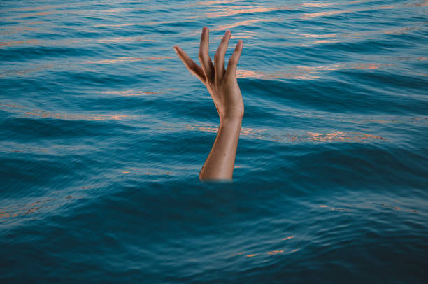 istock Drowning victims, Hand of drowning man needing help. 1448023511