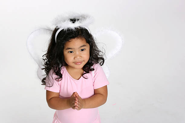 cute litle girl dressed up like an angel with wings and halo