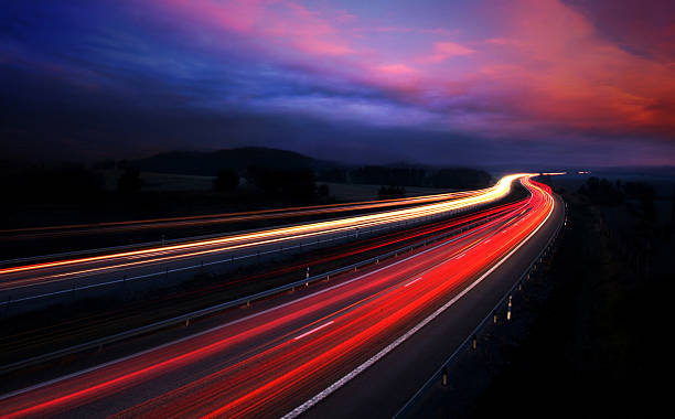 istock Illuminated road at night, motion blur creating the effect 144802620