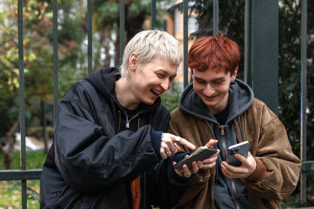 istock Two young men having a good time while looking at mobile phone. 1448026305