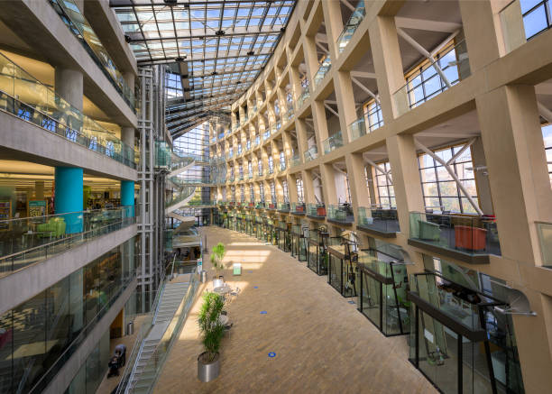 Interior view of a modern Bangkok university. Empty learning stations stretch across the area.