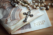 church finances, The concept of financing a church in Poland, Payment to a priest for a carol a bundle of banknotes and a rosary