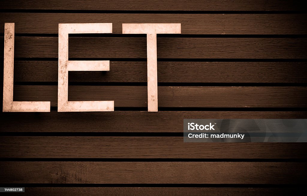 Let Monochrome LET sign text on a Wooden architectural background. Horizontal Stock Photo