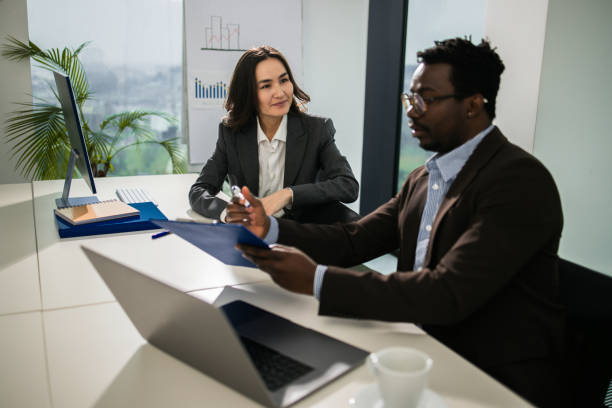 istock Two colleagues having a discussion in modern office 1448027505