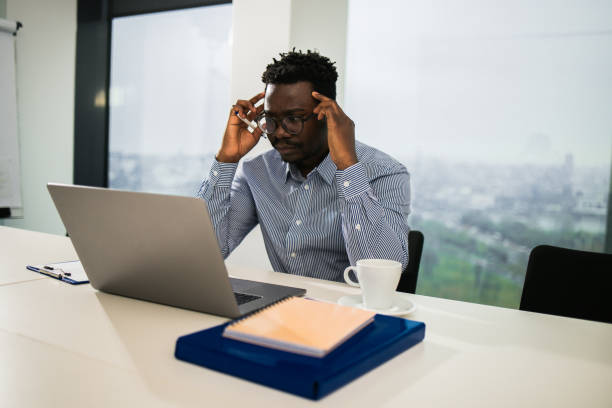 istock Young businessman using a laptop in a modern office 1448027560