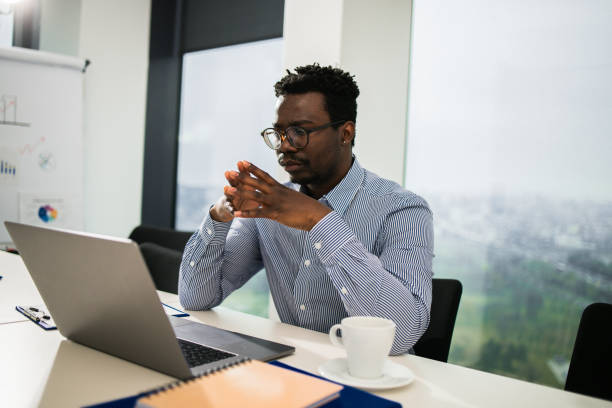 istock Young businessman using a laptop in a modern office 1448027565