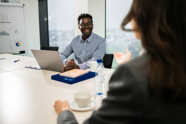 istock Two colleagues having a discussion in modern office 1448027581