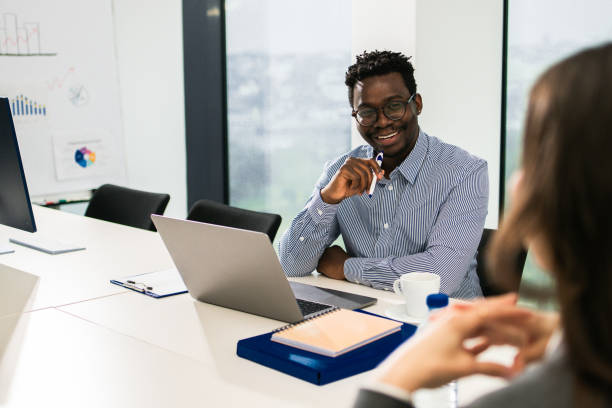 istock Two colleagues having a discussion in modern office 1448027584