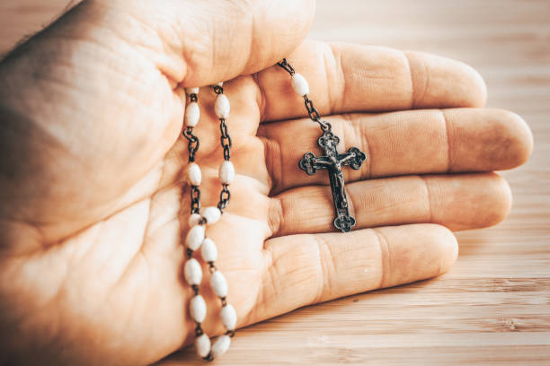 istock Hand with rosary, Catholic faith and prayer concept 1448027810