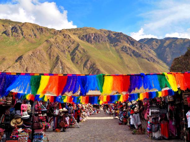 Flags in Ollantaytambo rainbow flags hanging in a market in Ollantaytambo urubamba province stock pictures, royalty-free photos & images