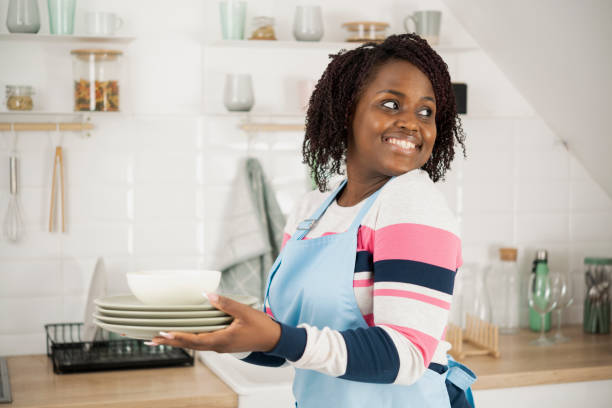istock Happy Afro woman arranging her kitchen 1448036066